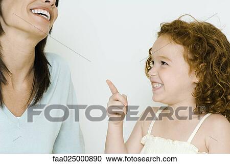 Stock Image - Little girl and mother, laughing. Fotosearch
