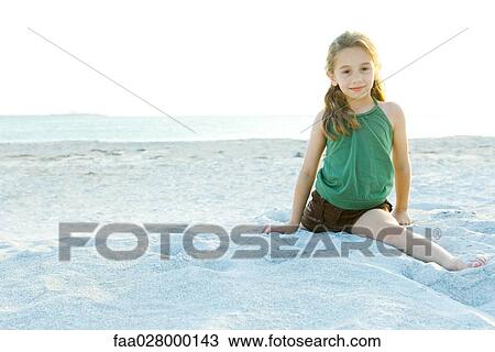 Little girl doing split at the beach, smiling at camera View Large Photo Image Stock Image - Little girl doing split at the beach, smiling at camera. Fotosearch