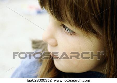 Stock Image - Little girl looking away, close-up, portrait. Fotosearch
