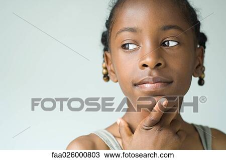 Little girl looking away, hand under chin, close-up View Large Photo Image Stock Image - Little girl looking away, hand under chin, close-up. Fotosearch