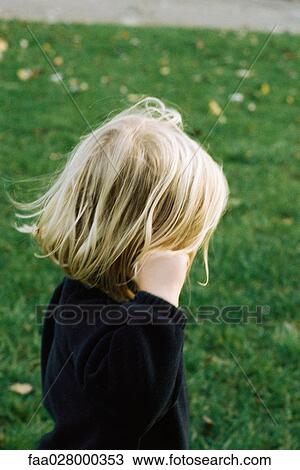 Little girl outdoors, hand in hair, side view View Large Photo Image Stock Image - Little girl outdoors, hand in hair, side view. Fotosearch