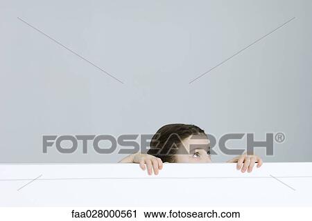 Little girl peeking over ledge View Large Photo Image Stock Image - Little girl peeking over ledge. Fotosearch