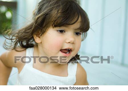 Little girl running outdoors, close-up View Large Photo Image Picture - Little girl running outdoors, close-up. Fotosearch