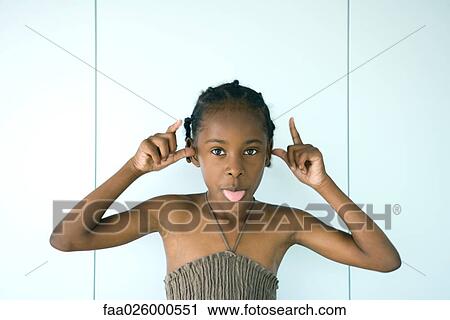 Little girl sticking tongue out at camera, arms raised, portrait View Large Photo Image Stock Image - Little girl sticking tongue out at camera, arms raised, portrait. Fotosearch
