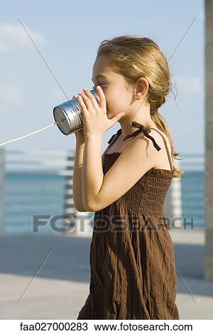 Little girl talking into tin can phone, side view View Large Photo Image Stock Image - Little girl talking into tin can phone, side view. Fotosearch