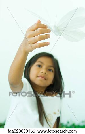 Little girl touching butterfly, low angle view View Large Photo Image Stock Photography - Little girl touching butterfly, low angle view. Fotosearch