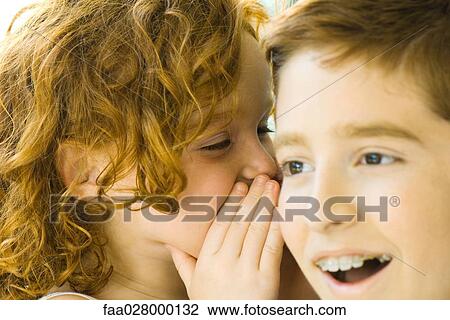 Little girl whispering in her brother's ear, close-up View Large Photo Image Stock Image - Little girl whispering in her brother's ear, close-up. Fotosearch