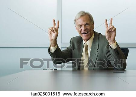 looking at camera, gesture, smiling, leaning on elbow, leaning against, businessman View Large Photo Image Stock Photograph - looking at camera, gesture, smiling, leaning on elbow, leaning against, businessman. Fotosearch