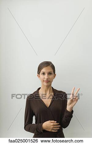 looking at camera, gesture, smiling, teenage girl, standing, peace sign, body language View Large Photo Image Stock Photograph - looking at camera, gesture, smiling, teenage girl, standing, peace sign, body language. Fotosearch