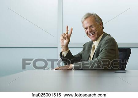 looking at camera, gesture, smiling, leaning against, businessman, ceo View Large Photo Image Stock Photography - looking at camera, gesture, smiling, leaning against, businessman, ceo. Fotosearch