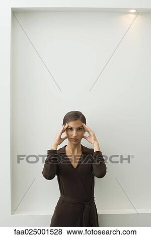 looking at camera, gesture, teenage girl, standing, headache, holding head, body language View Large Photo Image Stock Photo - looking at camera, gesture, teenage girl, standing, headache, holding head, body language. Fotosearch