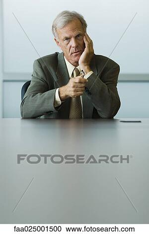 looking at camera, leaning on elbow, glasses, businessman, holding, holding head View Large Photo Image Stock Image - looking at camera, leaning on elbow, glasses, businessman, holding, holding head. Fotosearch