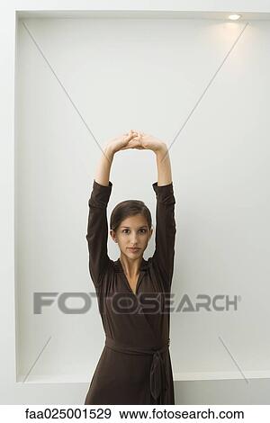 looking at camera, teenage girl, standing, stretching, clasped hands, arms raised, break View Large Photo Image Stock Photo - looking at camera, teenage girl, standing, stretching, clasped hands, arms raised, break. Fotosearch