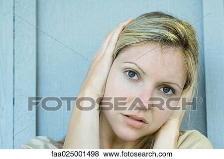 looking at camera, woman, covering ears, hands over ears, young women, noise, protection View Large Photo Image Stock Photo - looking at camera, woman, covering ears, hands over ears, young women, noise, protection. Fotosearch