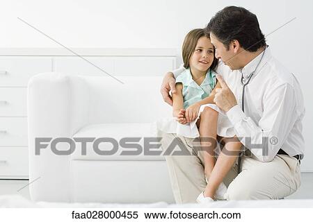 Male doctor talking with young patient, girl sitting on his lap View Large Photo Image Stock Photography - Male doctor talking with young patient, girl sitting on his lap. Fotosearch