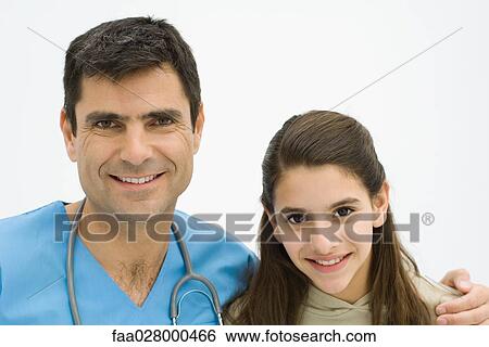 Male doctor with arm around girl's shoulder, both smiling at camera, portrait View Large Photo Image Stock Photograph - Male doctor with arm around girl's shoulder, both smiling at camera, portrait. Fotosearch