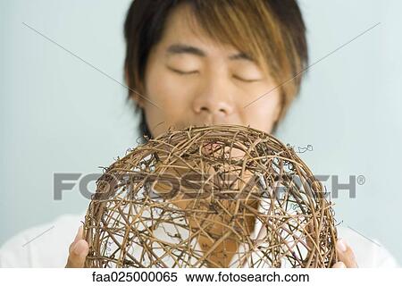 Man holding sphere, eyes closed View Large Photo Image Stock Photography - Man holding sphere, eyes closed. Fotosearch