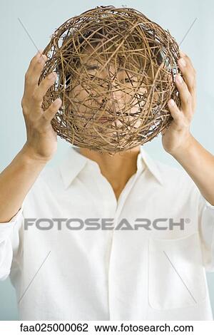 Man holding sphere in front of face View Large Photo Image Stock Image - Man holding sphere in front of face. Fotosearch