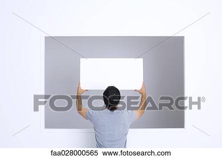 Man holding up blank sign, rear view View Large Photo Image Stock Photography - Man holding up blank sign, rear view. Fotosearch
