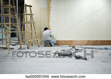Man installing wallboard View Large Photo Image Stock Photography - Man installing wallboard. Fotosearch