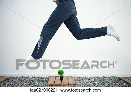Man jumping in the air over bonsai, side view, cropped View Large Photo Image Stock Image - Man jumping in the air over bonsai, side view, cropped. Fotosearch