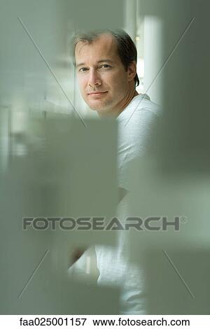 Stock Photo - Man looking at camera, selective focus. Fotosearch
