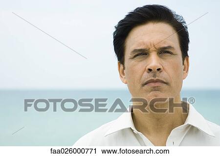 Man looking away, sea in background, portrait View Large Photo Image Stock Image - Man looking away, sea in background, portrait. Fotosearch