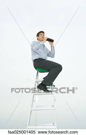 Man sitting on top of ladder, holding binoculars, looking up View Large Photo Image Stock Photography - Man sitting on top of ladder, holding binoculars, looking up. Fotosearch