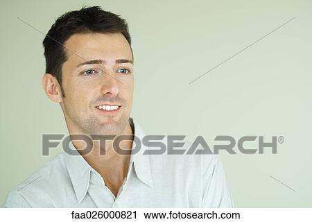 Man smiling, looking out of frame, head and shoulders, portrait View Large Photo Image Stock Image - Man smiling, looking out of frame, head and shoulders, portrait. Fotosearch