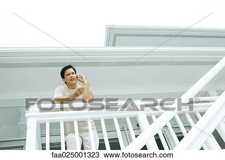 Man standing on deck using cell phone, making order with credit card View Large Photo Image Stock Image - Man standing on deck using cell phone, making order with credit card. Fotosearch