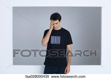 Man wearing tee-shirt printed with bar code, covering face with hand View Large Photo Image Stock Photography - Man wearing tee-shirt printed with bar code, covering face with hand. Fotosearch