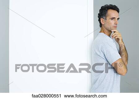 Man with arms folded and hand under chin, waist up View Large Photo Image Stock Image - Man with arms folded and hand under chin, waist up. Fotosearch
