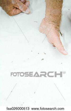 Man with hand half-buried in sand, cropped view, close-up View Large Photo Image Stock Image - Man with hand half-buried in sand, cropped view, close-up. Fotosearch
