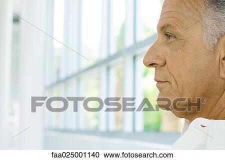 Mature man, profile, window in background, cropped View Large Photo Image Stock Image - Mature man, profile, window in background, cropped. Fotosearch