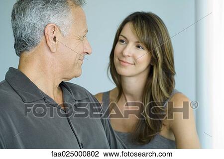 Mature man smiling at adult daughter, close-up View Large Photo Image Stock Image - Mature man smiling at adult daughter, close-up. Fotosearch