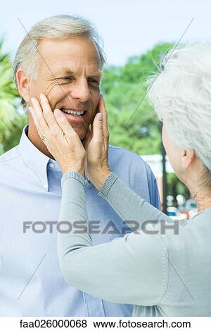 Mature woman touching her husband's face, close-up View Large Photo Image Stock Photo - Mature woman touching her husband's face, close-up. Fotosearch