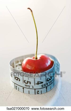 Measuring tape wrapped around cherry, close-up View Large Photo Image Stock Image - Measuring tape wrapped around cherry, close-up. Fotosearch