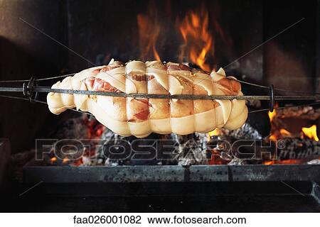 Stock Image - Meat roasting over fire, close-up. Fotosearch