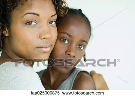 Mother and daughter embracing, looking at camera, portrait View Large Photo Image Stock Photography - Mother and daughter embracing, looking at camera, portrait. Fotosearch