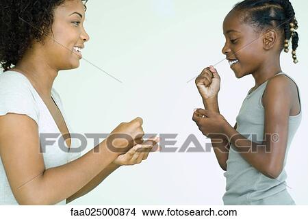 Mother and daughter playing rock paper scissors, side view View Large Photo Image Picture - Mother and daughter playing rock paper scissors, side view. Fotosearch