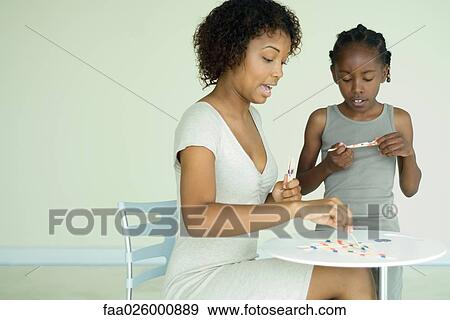 Mother and daughter playing with pick up sticks together View Large Photo Image Stock Photo - Mother and daughter playing with pick up sticks together. Fotosearch