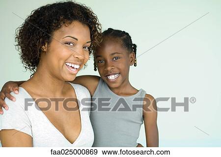 Mother and daughter smiling at camera, close-up, portrait View Large Photo Image Stock Photo - Mother and daughter smiling at camera, close-up, portrait. Fotosearch