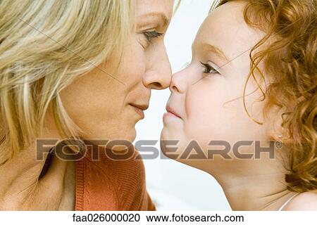 Mother and daughter touching noses, cropped side view View Large Photo Image Stock Image - Mother and daughter touching noses, cropped side view. Fotosearch