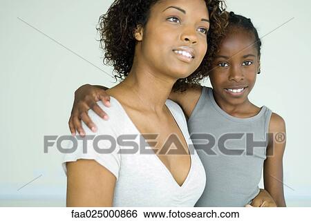 Mother holding daughter, both smiling, girl looking at camera View Large Photo Image Stock Photograph - Mother holding daughter, both smiling, girl looking at camera. Fotosearch