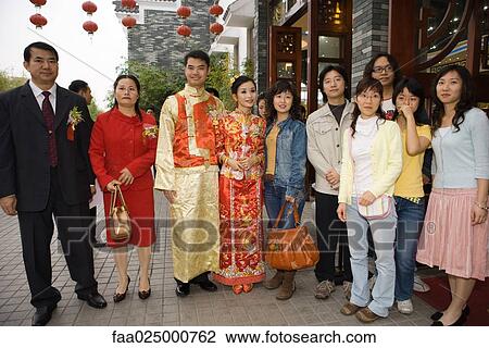 Newlyweds dressed in traditional Chinese clothing, standing with family, group portrait View Large Photo Image Stock Image - Newlyweds dressed in traditional Chinese clothing, standing with family, group portrait. Fotosearch