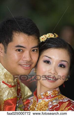 Newlyweds in traditional Chinese clothing, cheek to cheek, smiling at camera View Large Photo Image Stock Image - Newlyweds in traditional Chinese clothing, cheek to cheek, smiling at camera. Fotosearch
