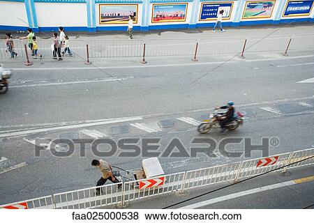 Pedestrians and motorcyclist on street, high angle view View Large Photo Image Stock Photo - Pedestrians and motorcyclist on street, high angle view. Fotosearch