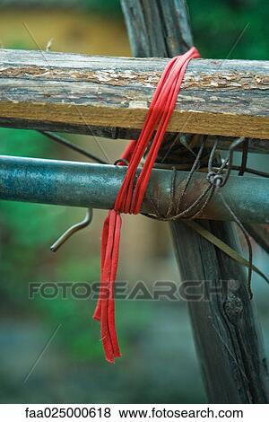 Piece of wood and metal tied together with red string View Large Photo Image Stock Photo - Piece of wood and metal tied together with red string. Fotosearch