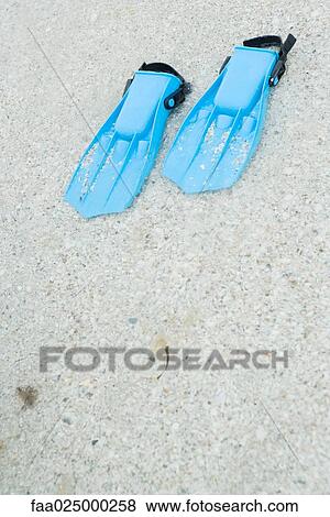 Plastic flippers on sand, close-up View Large Photo Image Stock Photo - Plastic flippers on sand, close-up. Fotosearch