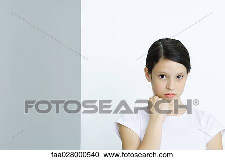 Preteen girl, hand under chin, looking at camera, portrait View Large Photo Image Stock Image - Preteen girl, hand under chin, looking at camera, portrait. Fotosearch